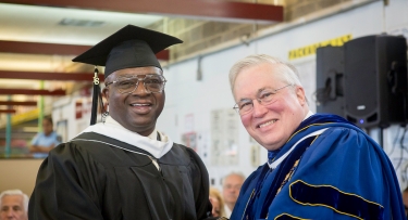 President Hall confers degrees for graduating class at Sing Sing Correctional Facility