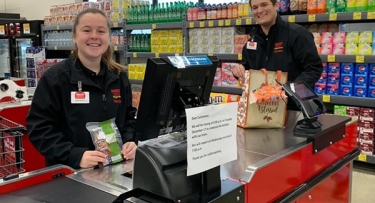 Woman and man in grocery store checkout