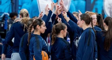 Mercy University Women's Basketball Team huddle before a game