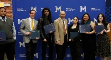 Mercy University students pose with their awards and Media Studies professor Louis Grassoat the 40th Annual Quill Awards