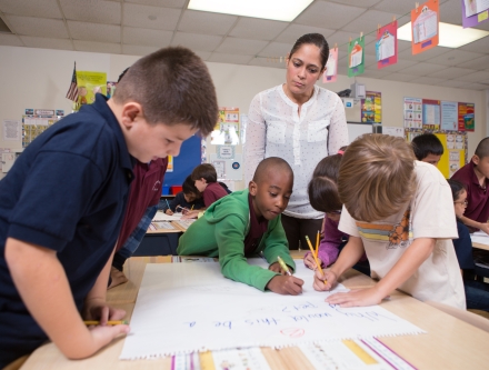 Kindergarten teacher watching her class at work.