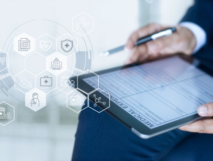 A Health Services Manager working on his tablet.