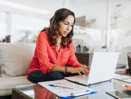 Woman at home with laptop